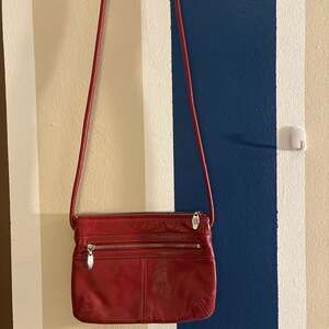 Tignanello Red Pebbled Leather Crossbody Bag with Triple Zipper Pockets